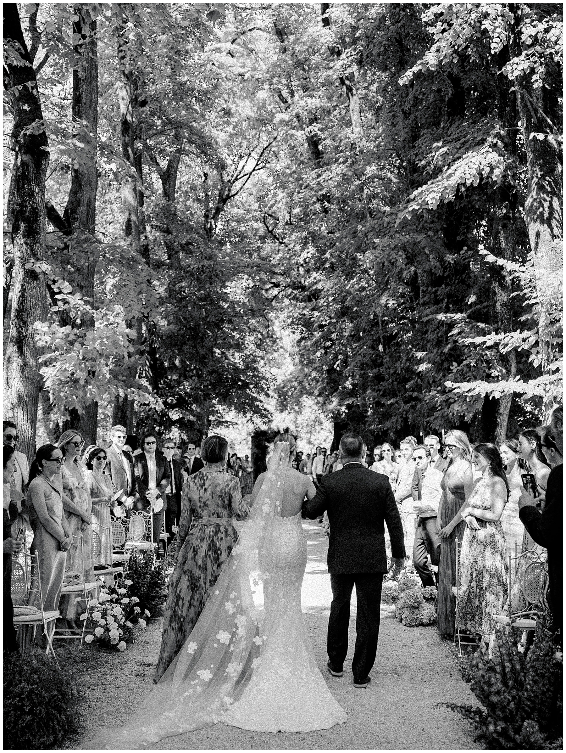 bride walks down aisle with parents