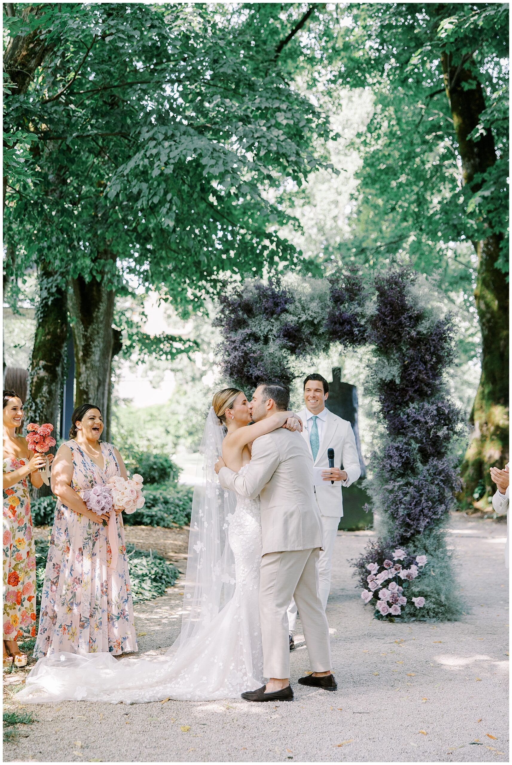 bride and groom kiss at wedding ceremony