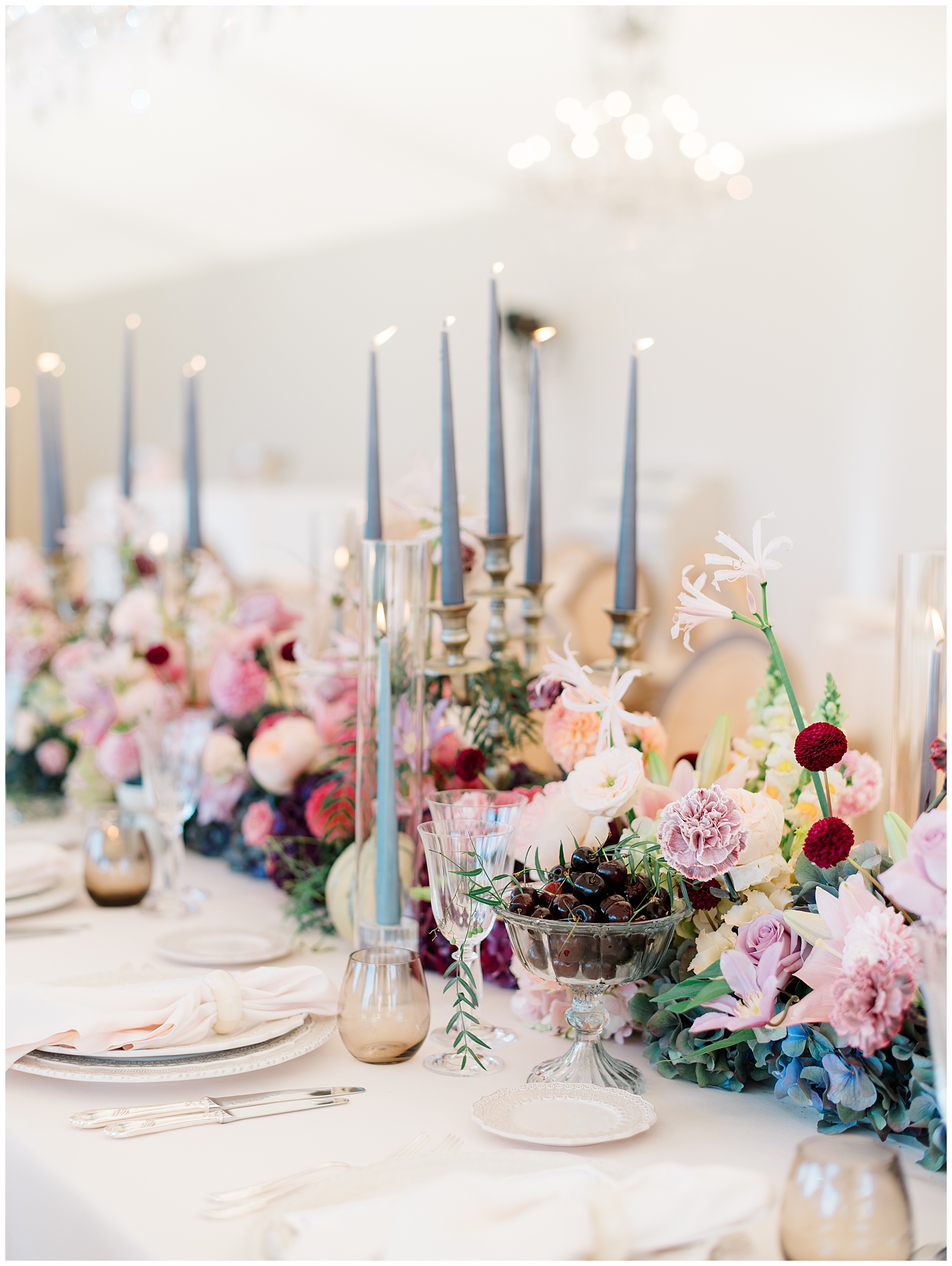 lush florals at center of table with candle light