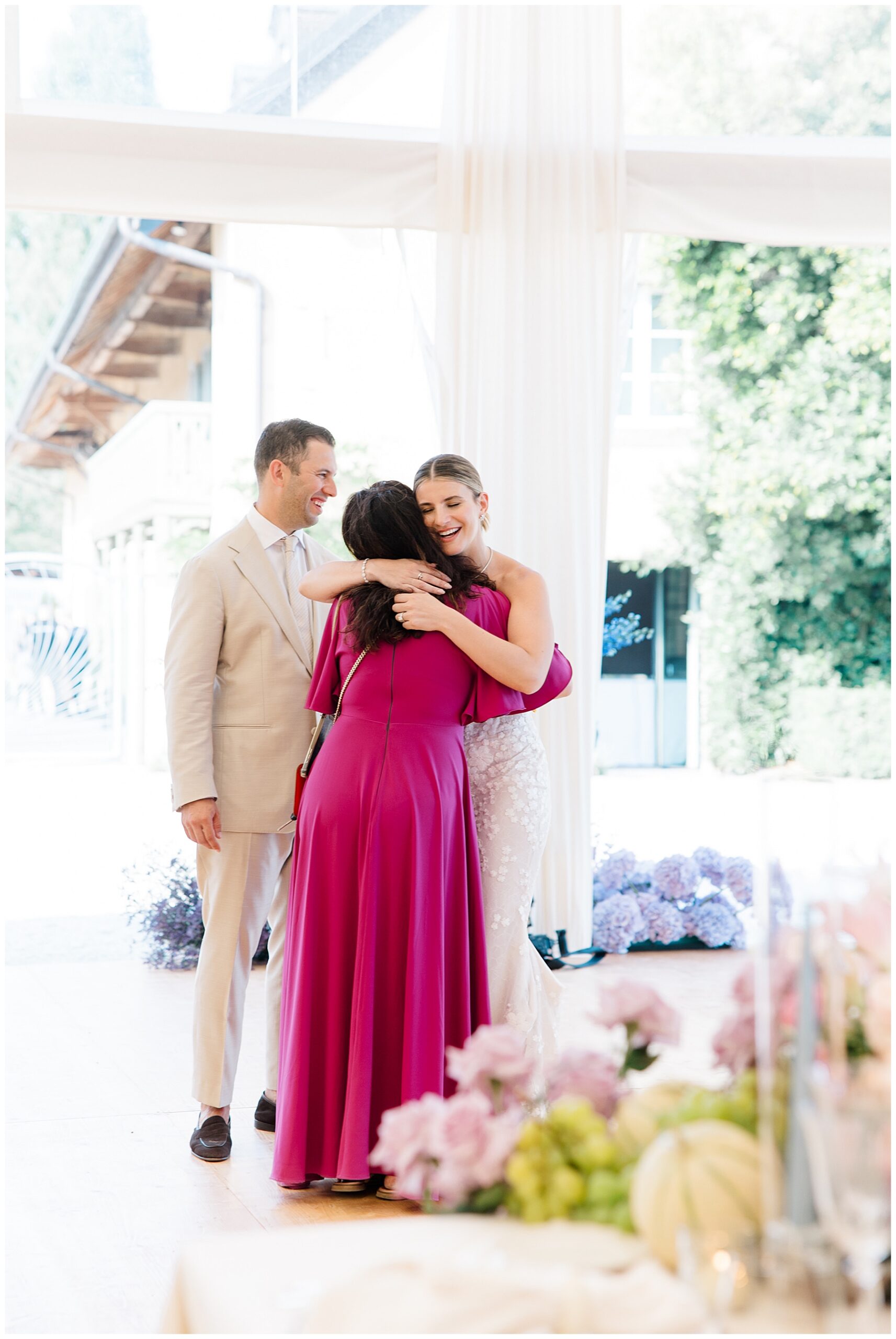 bride and groom hug wedding planner