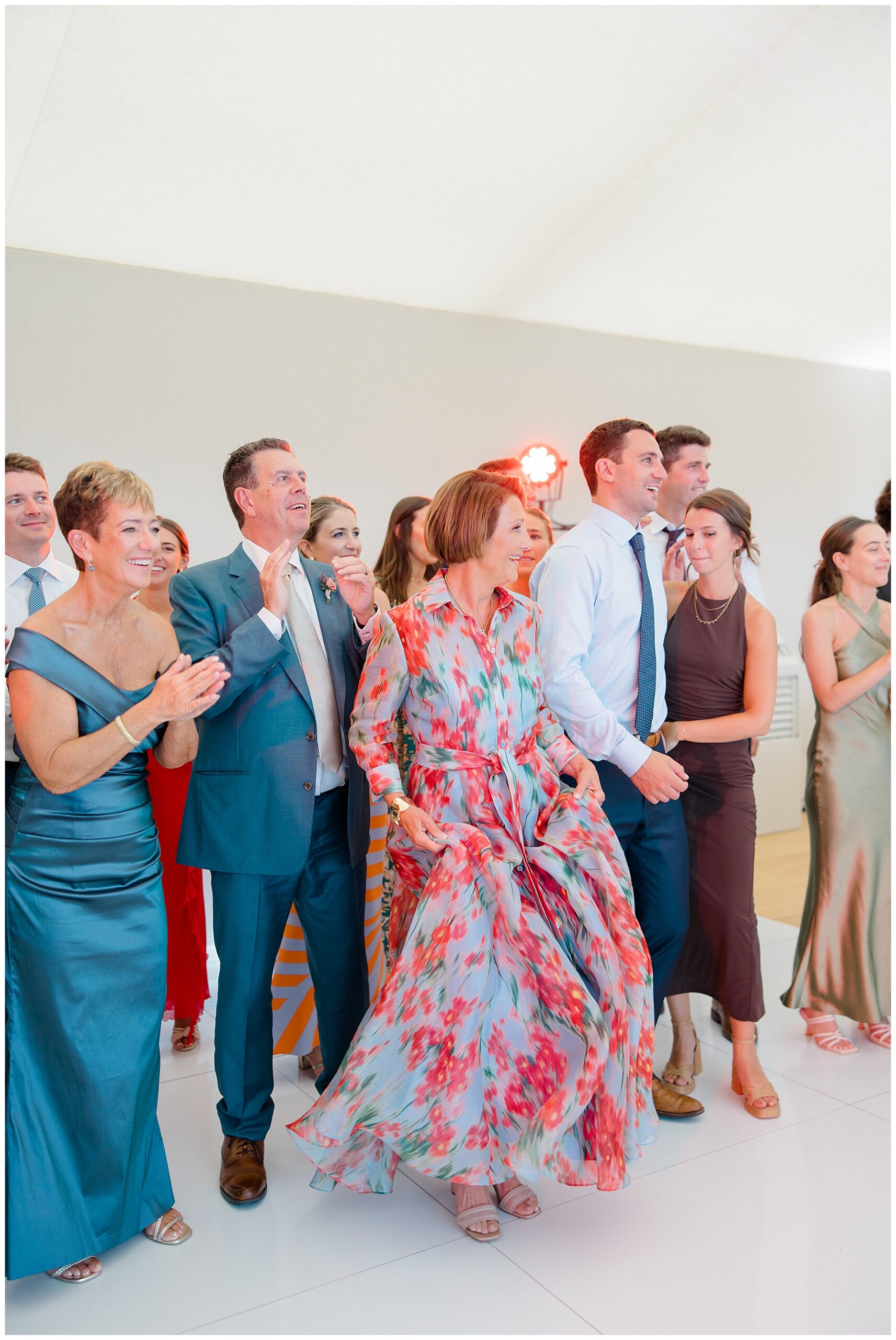 guests surround dance floor as couple share first dance