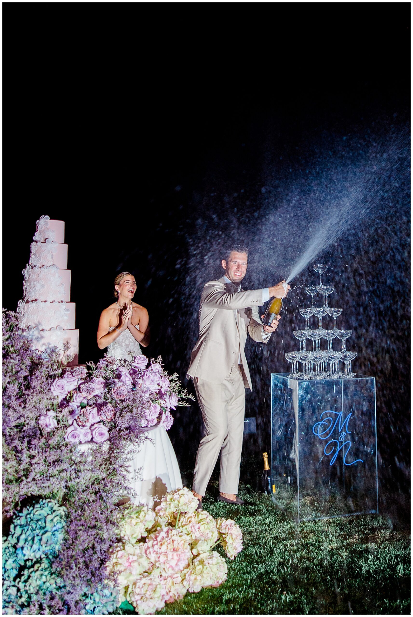 groom opens bottle of champagne