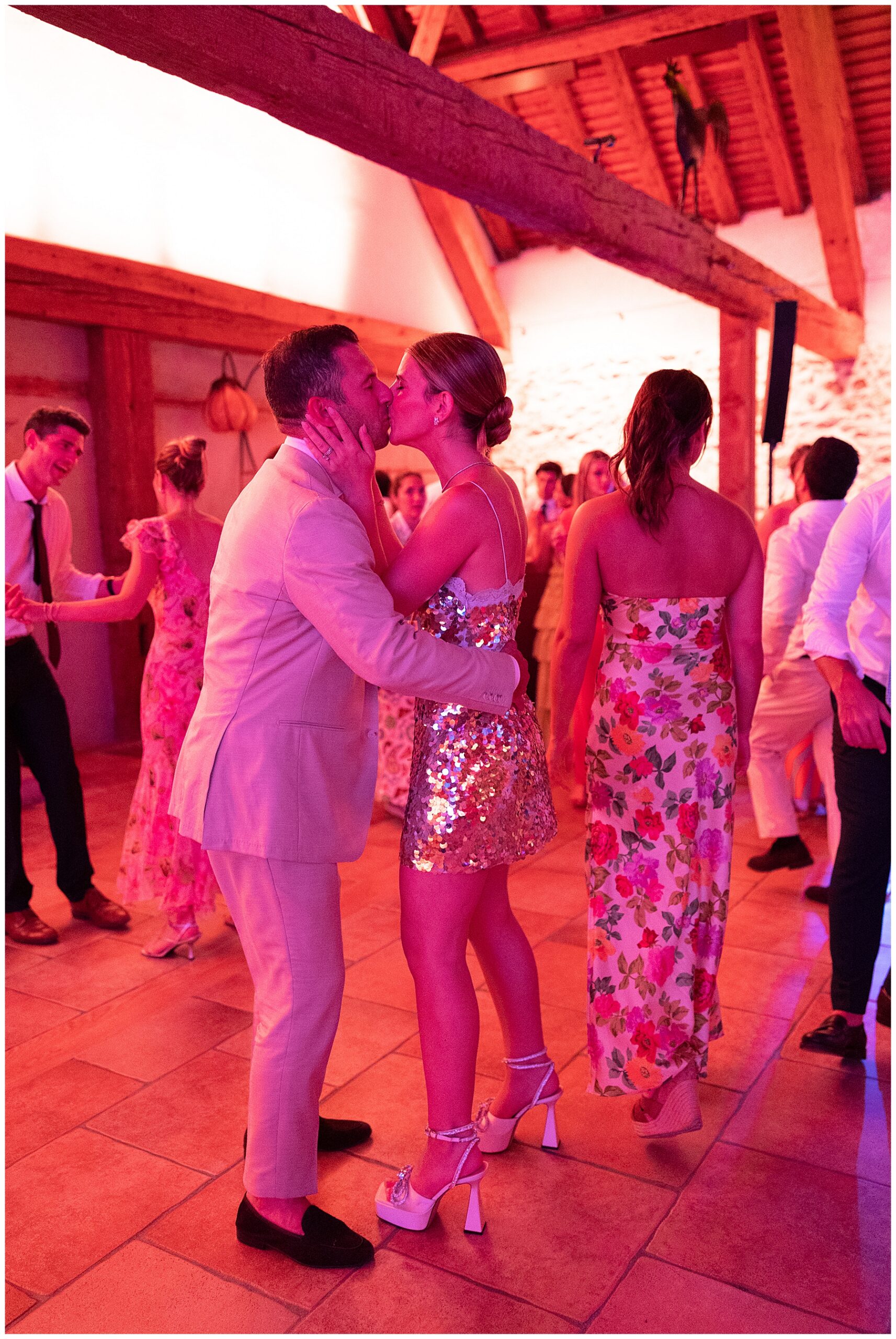 bride and groom kiss on dance floor at afterparty