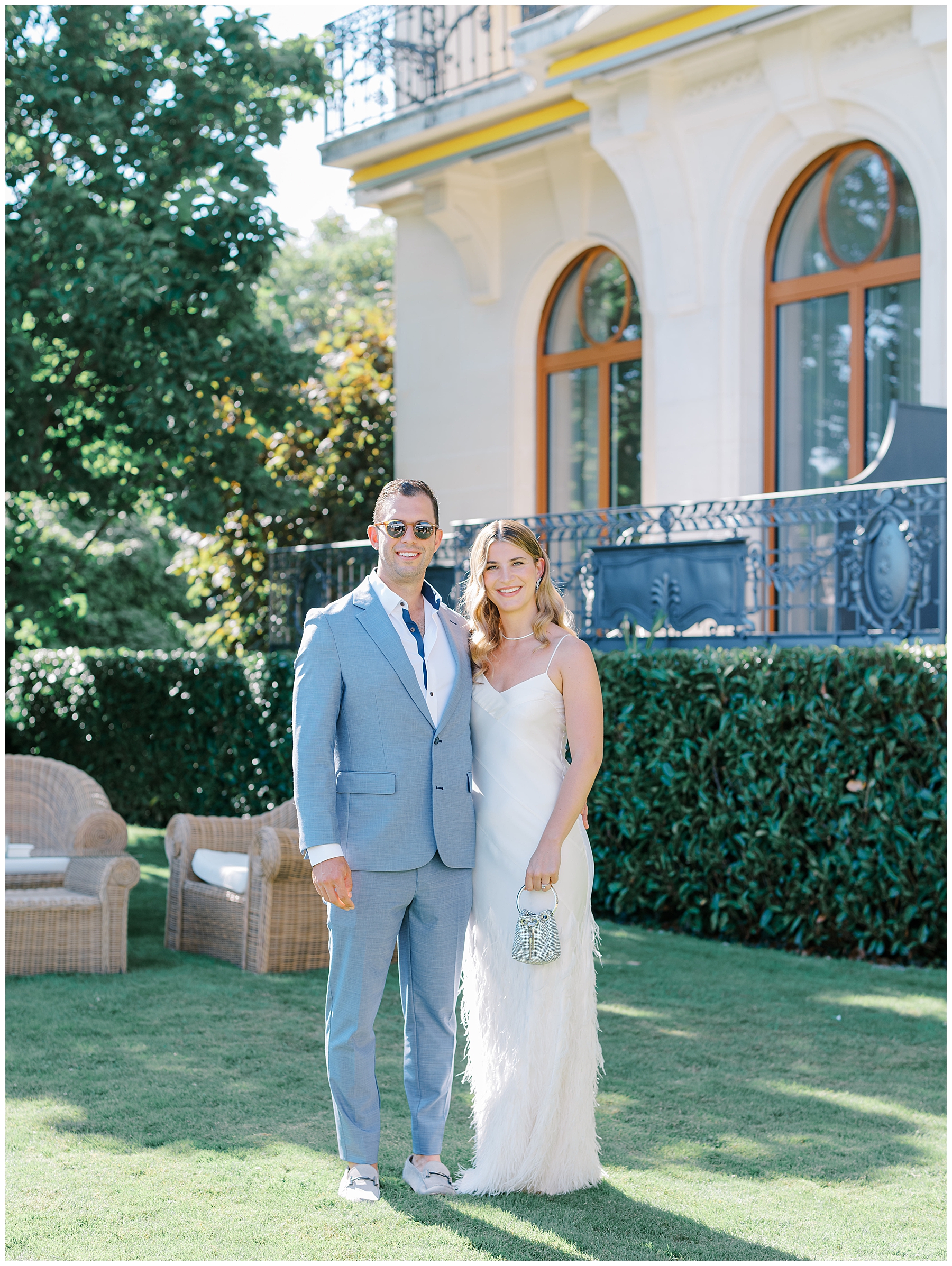 couple on lawn of Beau-Rivage Palace in Lausanne, Switzerland for wedding welcome party