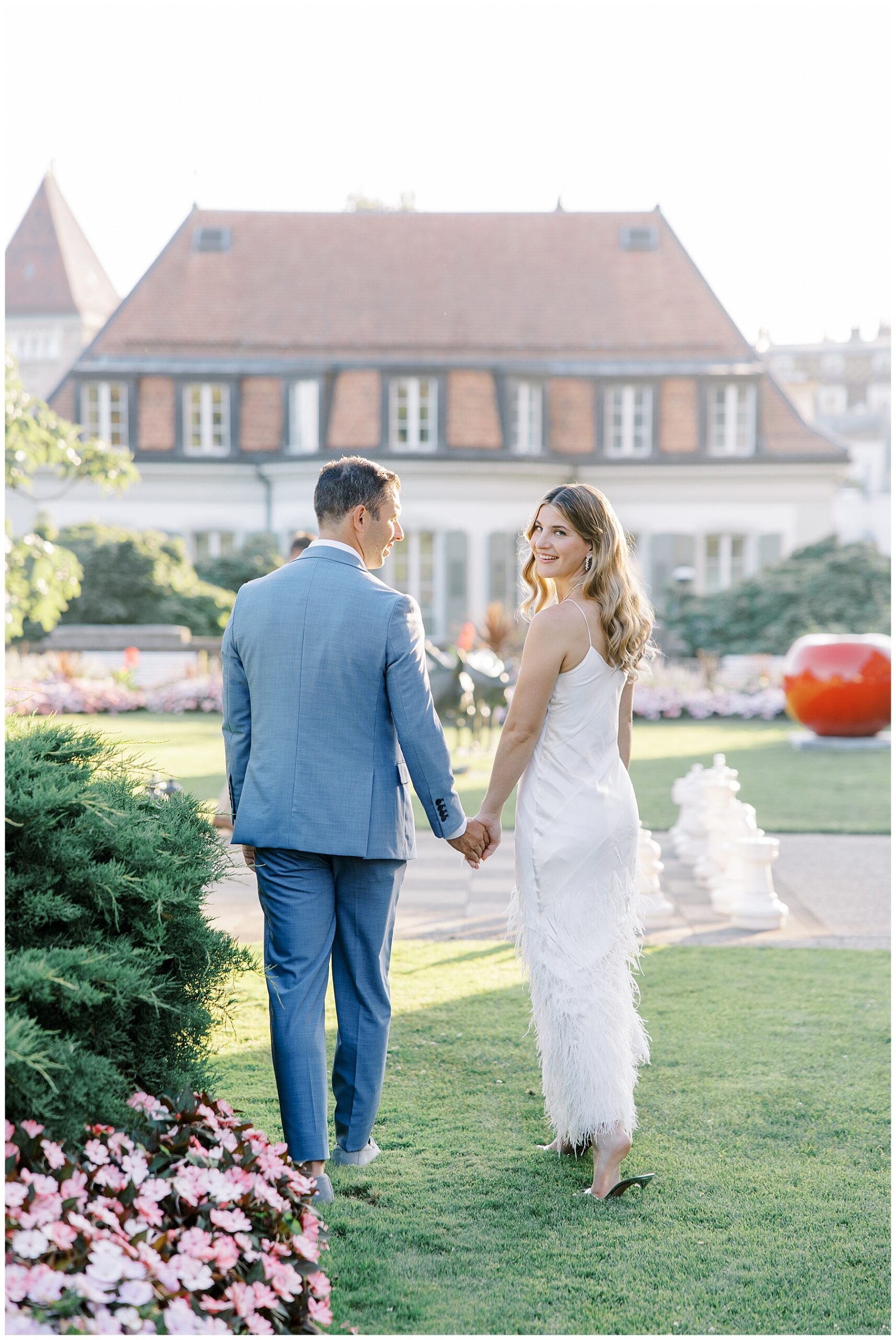 couple hold hands as they walk together 