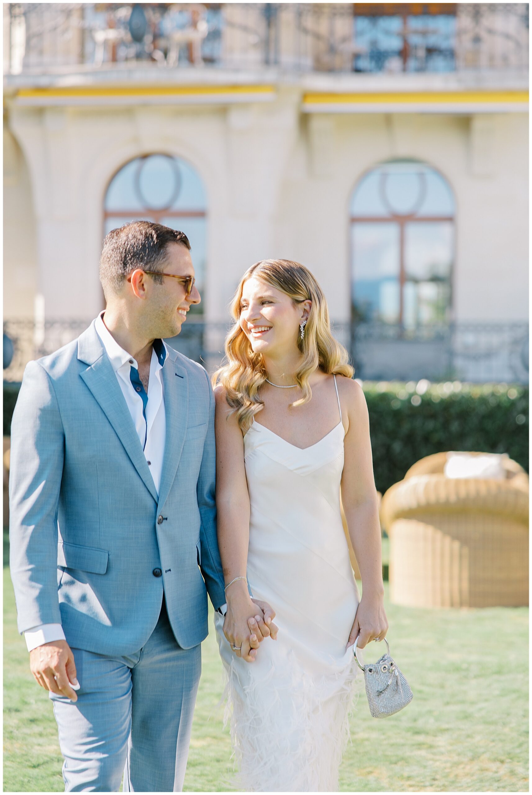couple holding hands at wedding welcome party in Switzerland