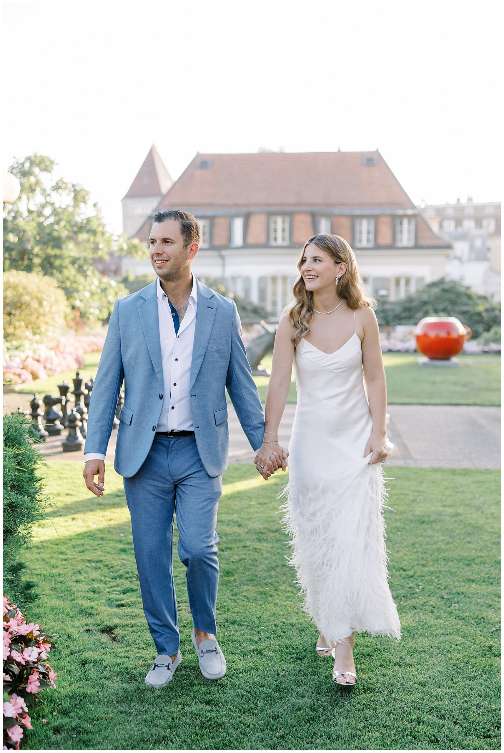 bride and groom to be walk together holding hands 