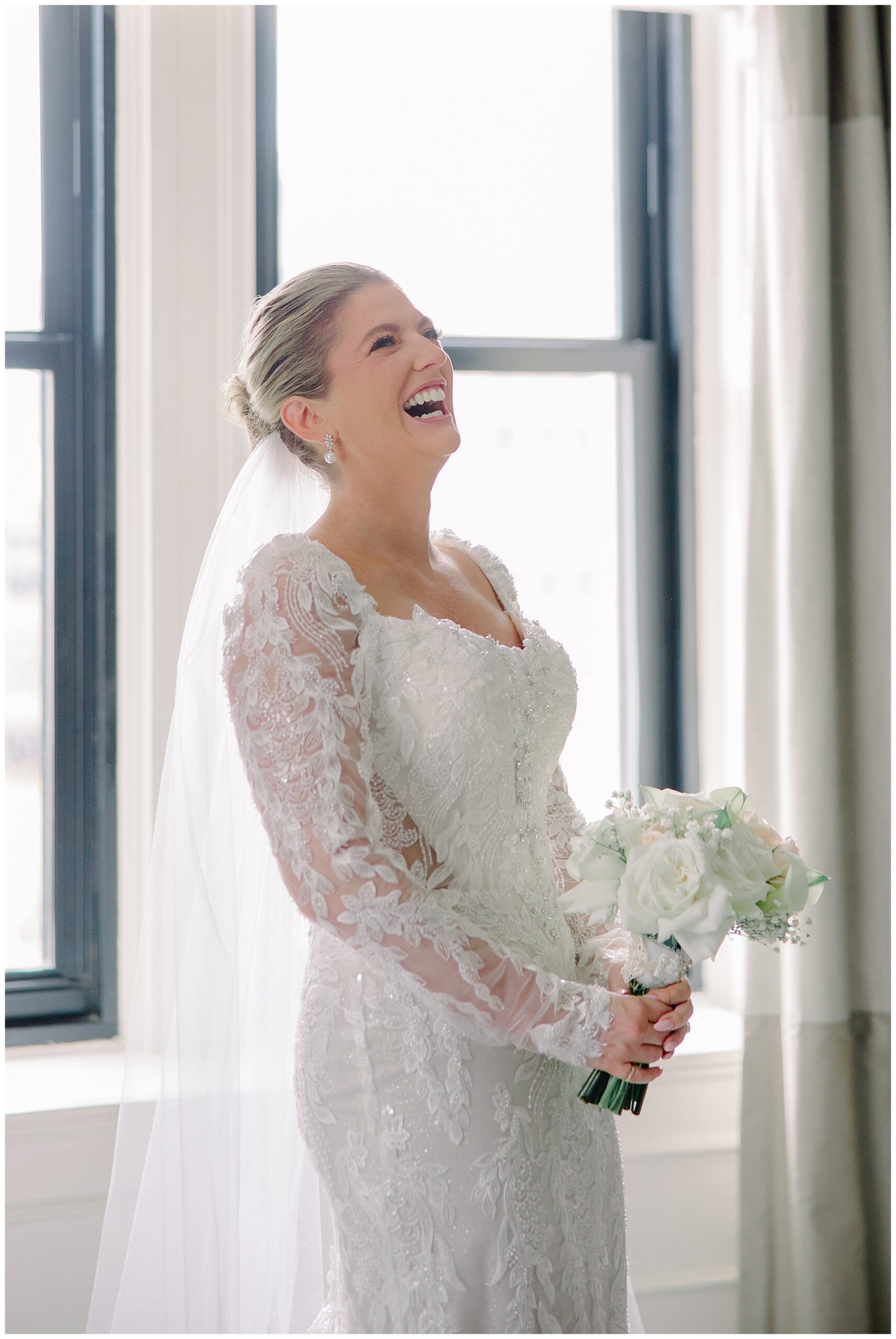 candid portraits of bride laughing holding wedding bouquet