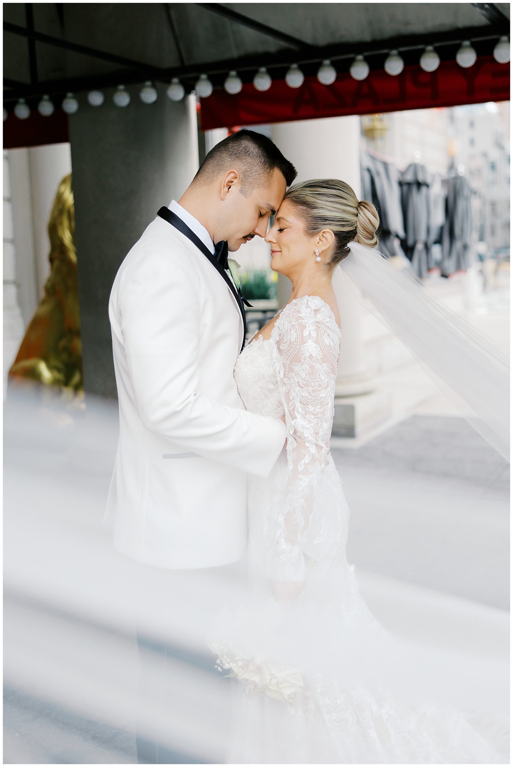 bride and groom touch their heads together in intimate wedding photos 
