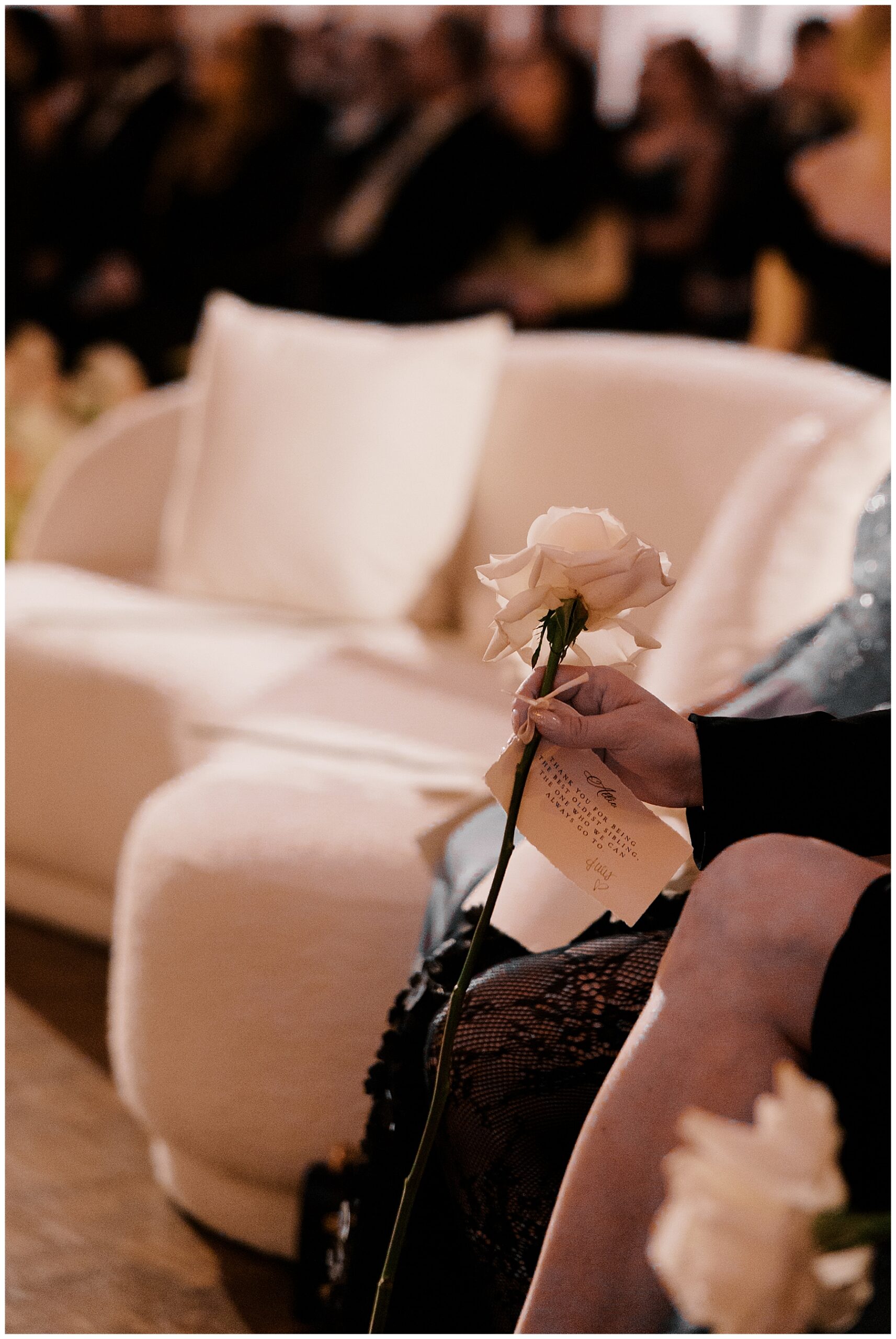 wedding guest holding a rose