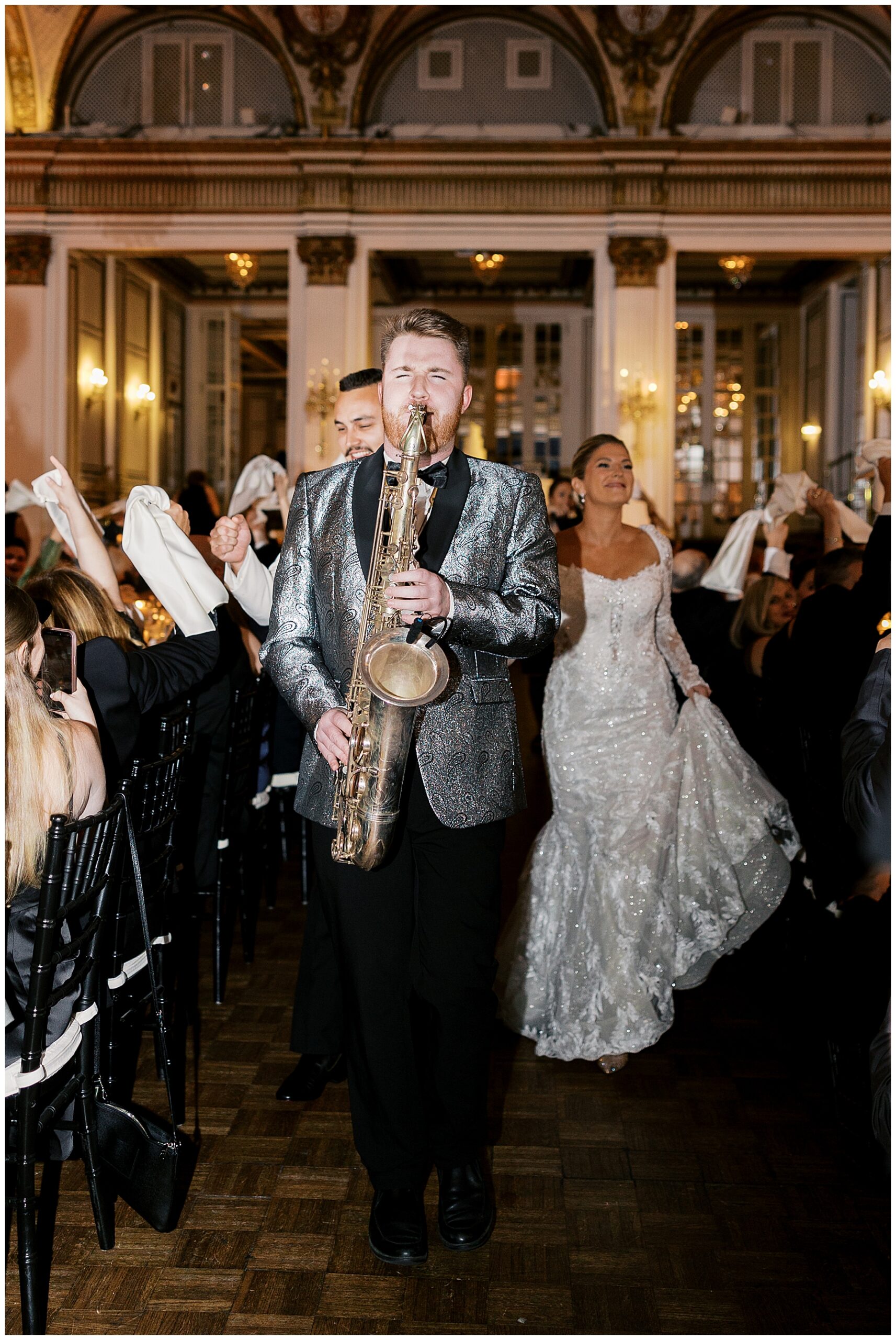 saxophone player plays for bride and groom's grand entrance
