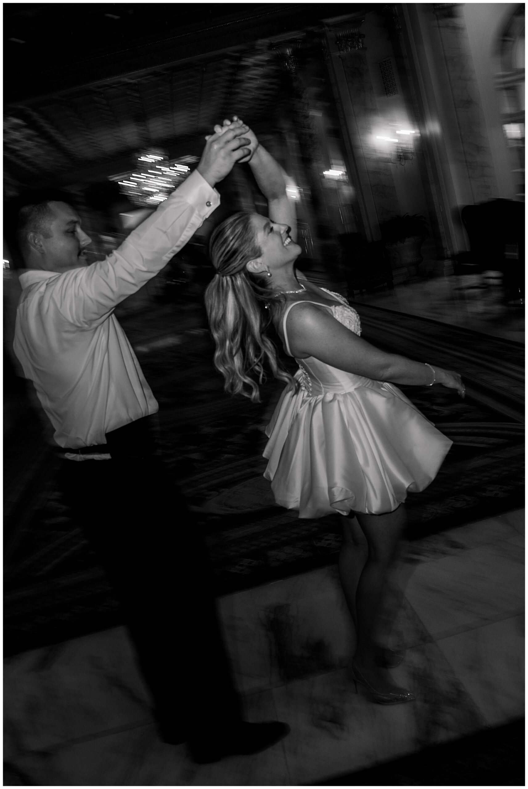 groom spins his bride around 