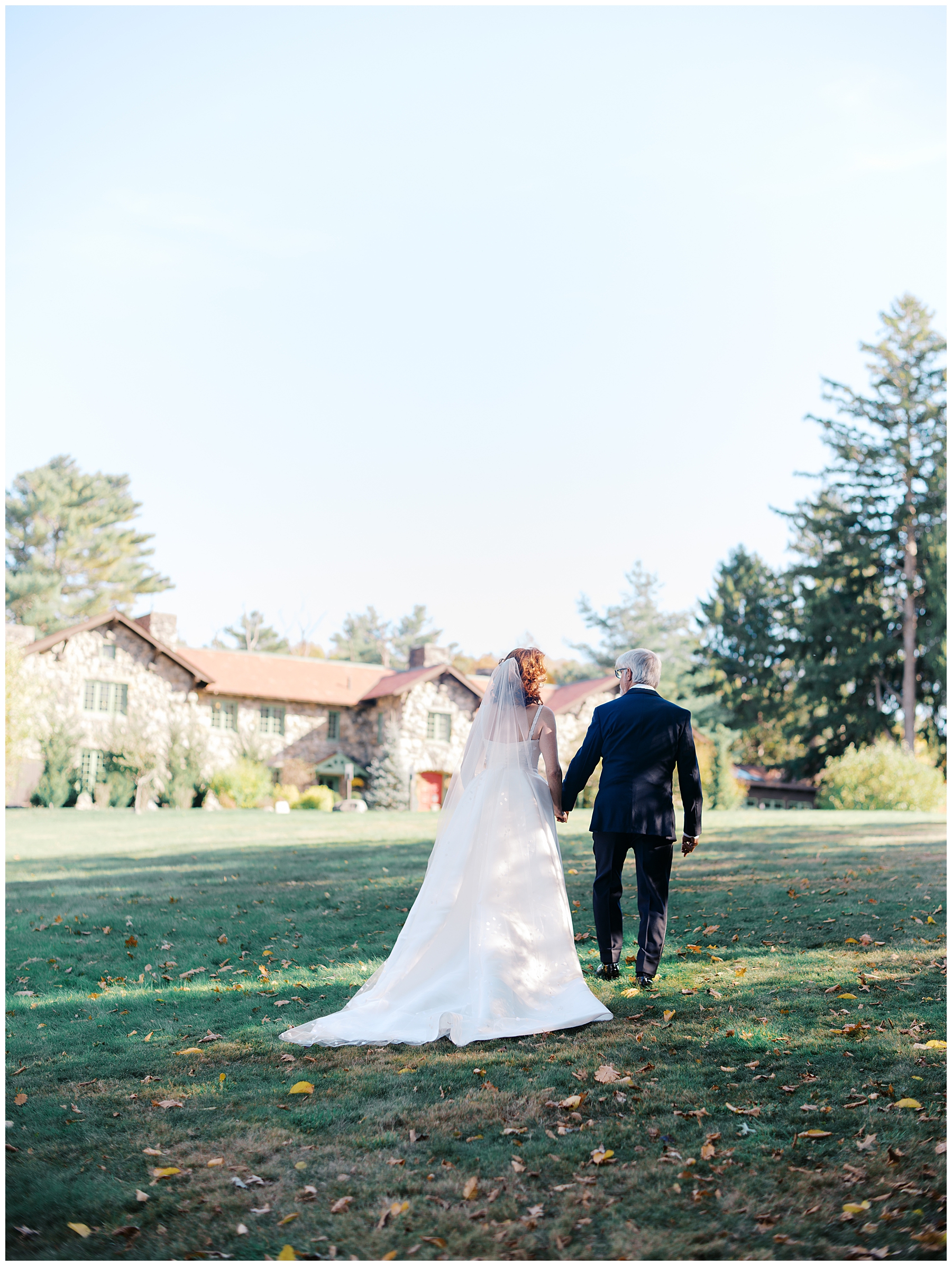 bride and groom walk together holding hands