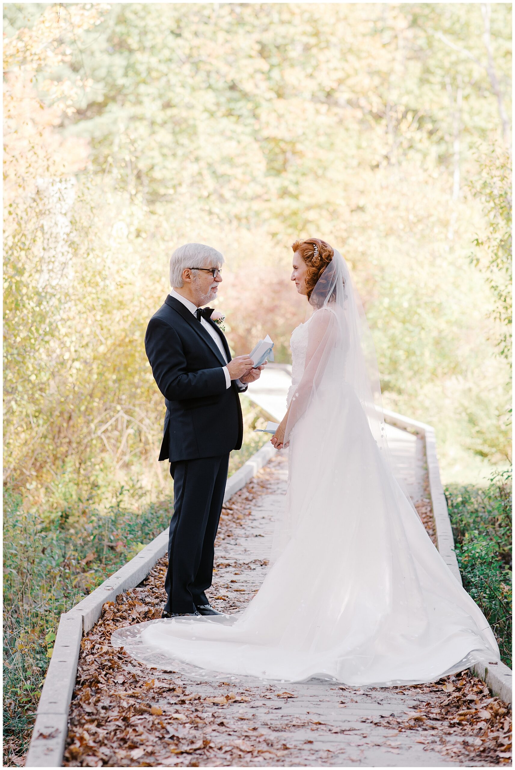 groom reads handwritten vows to wife during first look