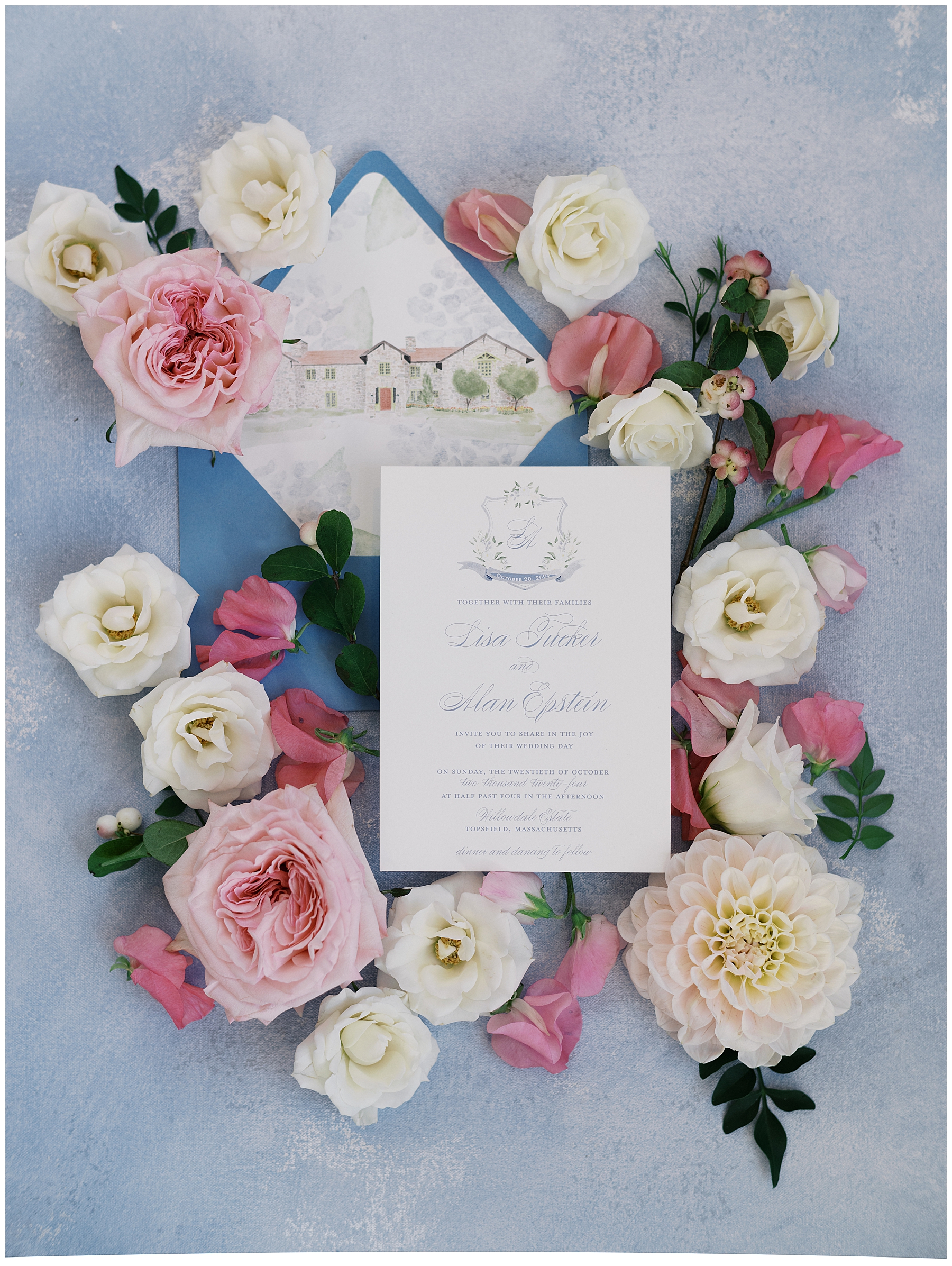 wedding invitation surrounded by soft florals