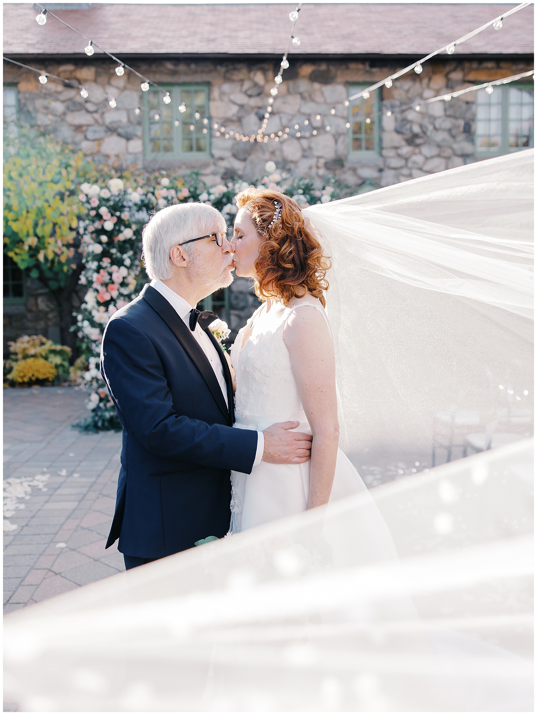 wedding portraits by floral arch