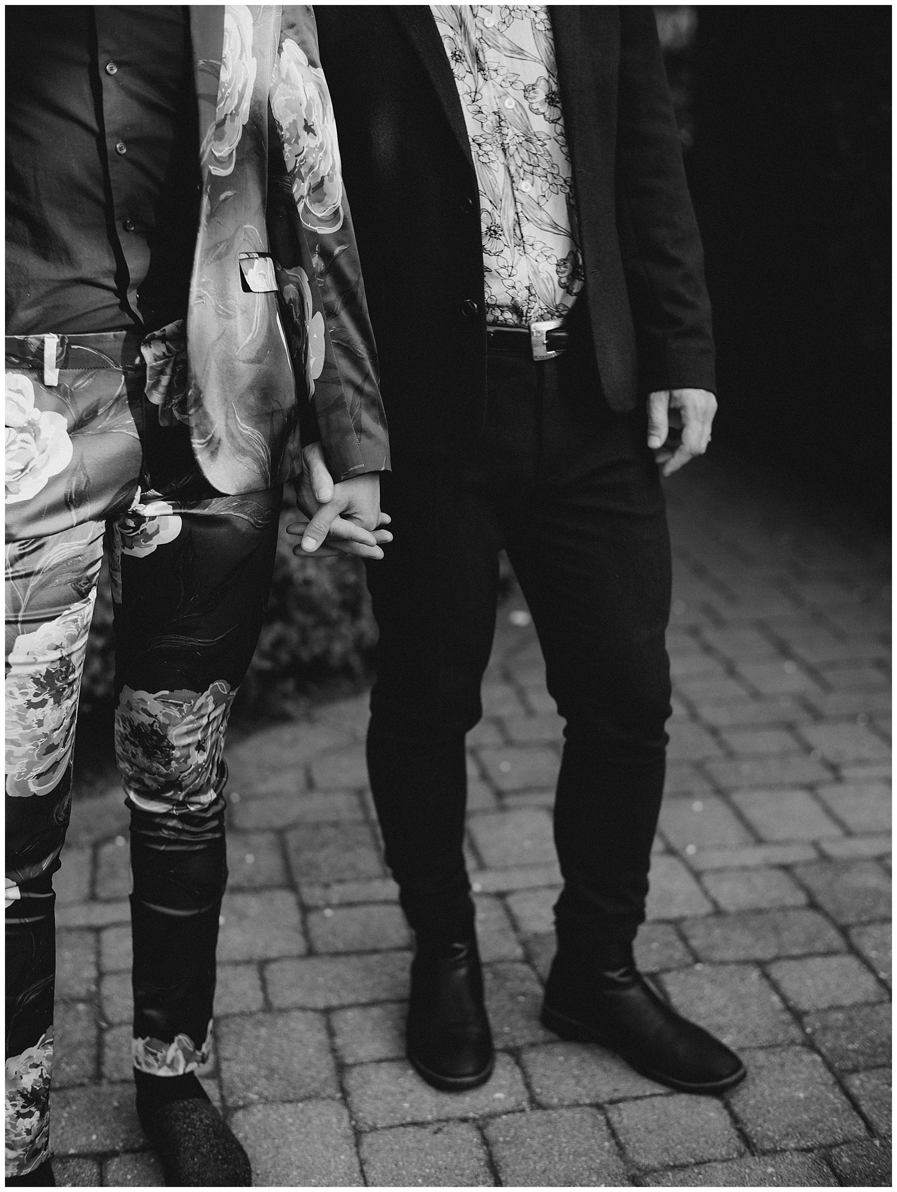 grooms hold hands