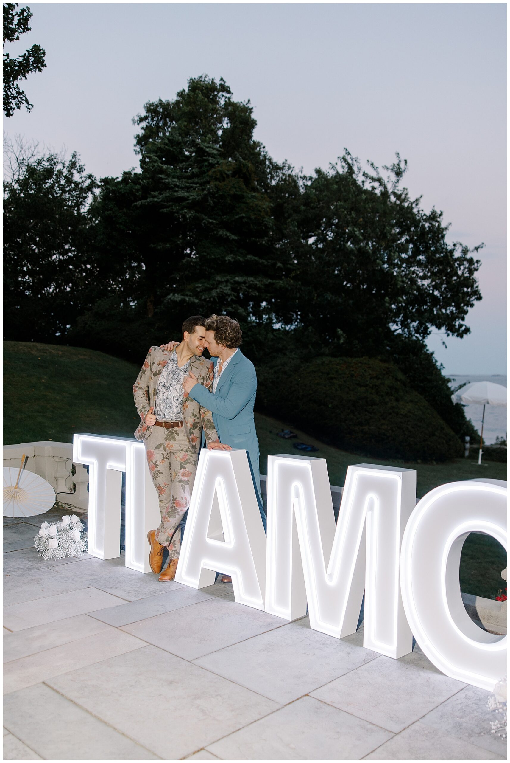 couple stand by Ti Amo sign at Italian-inspired wedding
